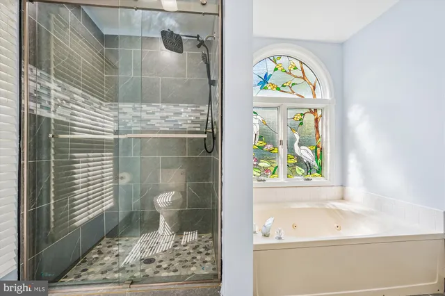 a bathroom with a bathtub and a window