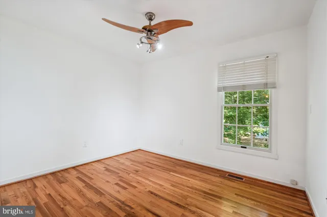 a view of a room with a window and a ceiling fan