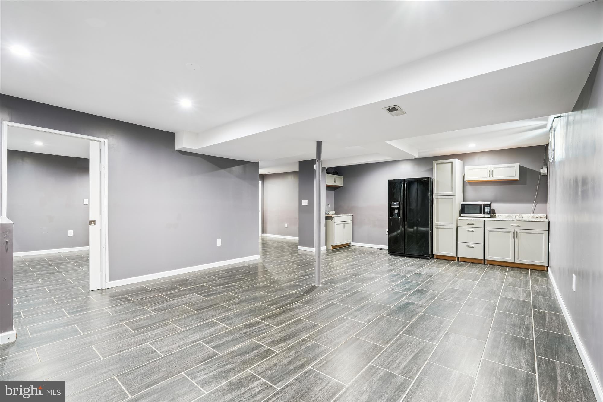 15418 Peach Orchard Road Silver Spring, MD 20905 - Photo 32 of 47 Spacious, basement with wet bar and cabinetry.