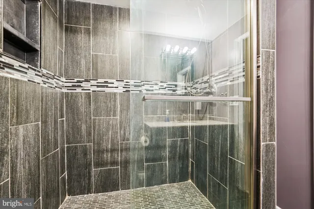 a bathroom with a shower and a sink