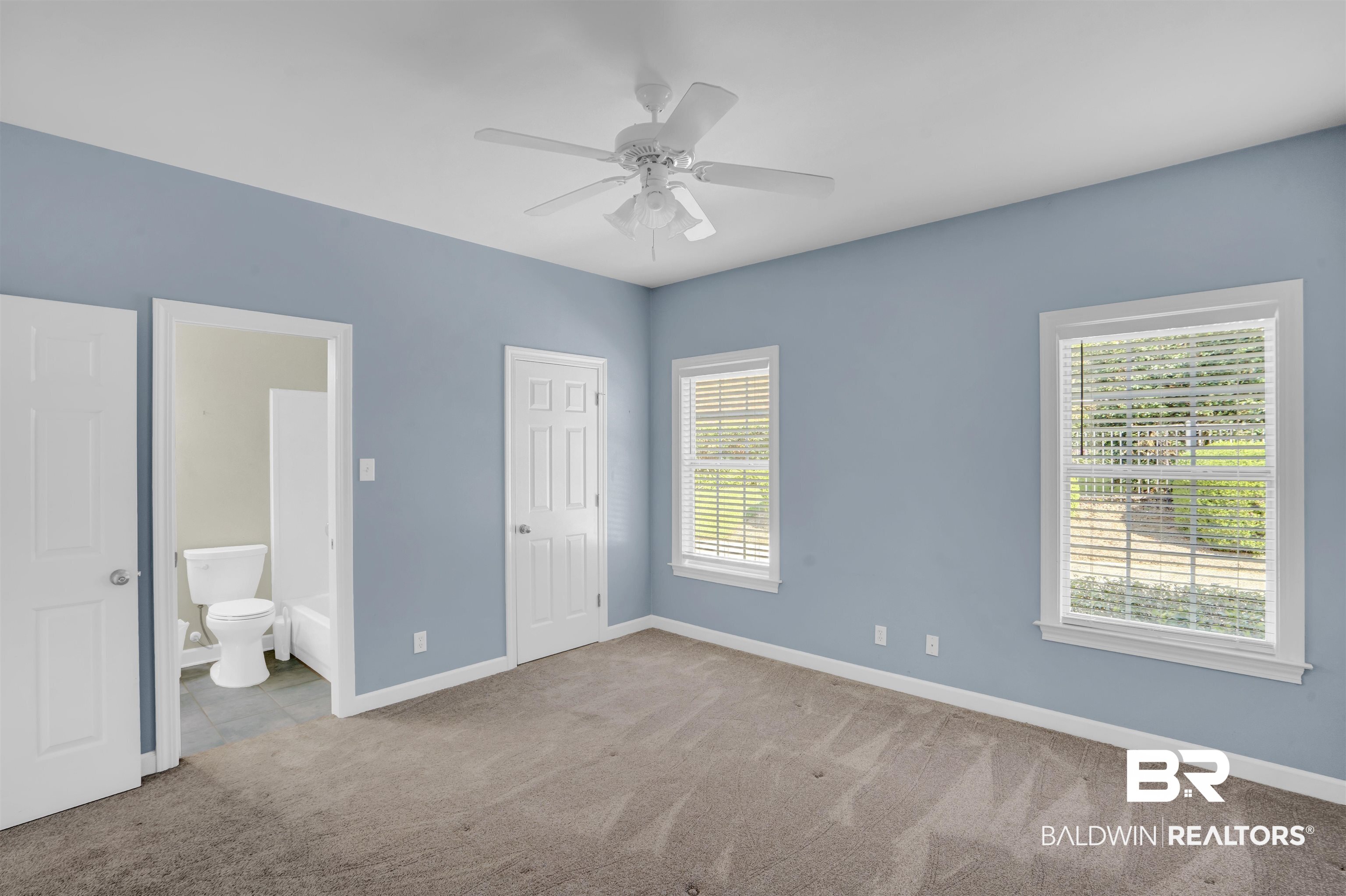 111 Beaver Dam Road Fairhope, AL 36532 - Photo 21 of 51 Unfurnished bedroom with ensuite bath, multiple windows, light colored carpet, and ceiling fan