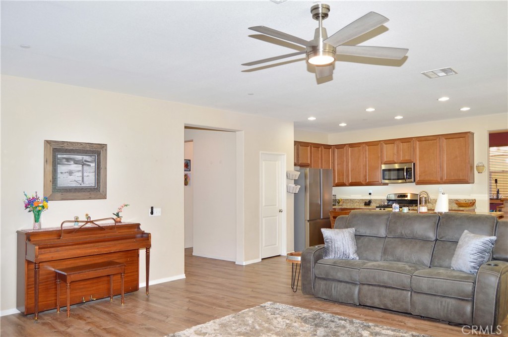 166 Fox Lane Calimesa, CA 92320 - Photo 14 of 76 Spacious Great-Room-Style Living Room with Fabulous Flooring, Ceiling Fan, and Backyard Views