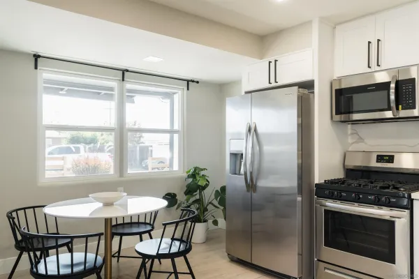a kitchen with stainless steel appliances granite countertop a stove a refrigerator and a microwave