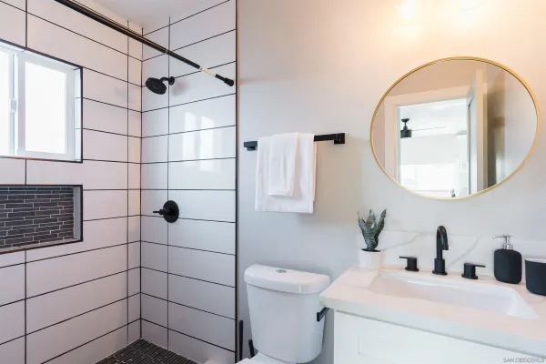 a bathroom with a sink toilet and shower