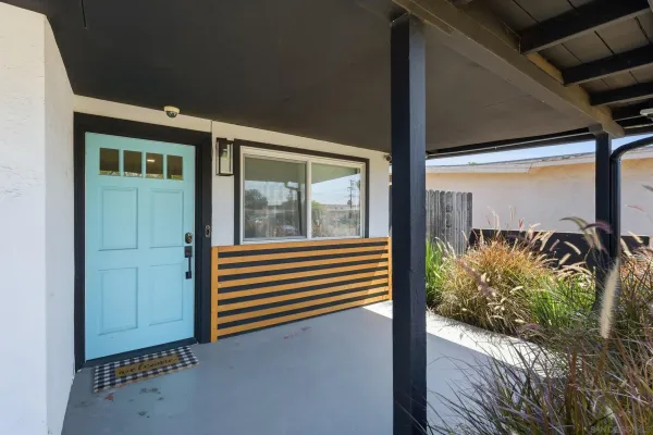 a view of a porch with a table and chairs and potted plants
