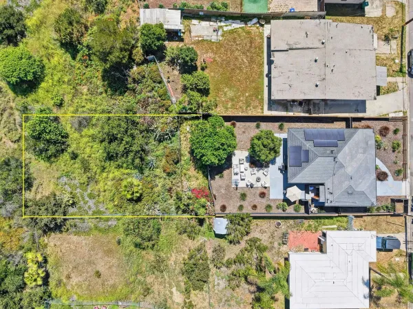 an aerial view of a house with a yard