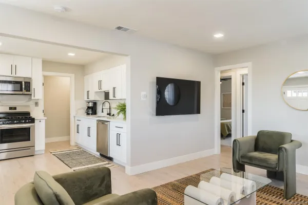 a living room with furniture and a wooden floor