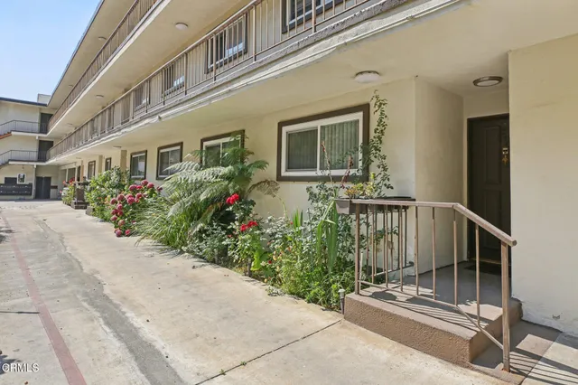 a flower garden is sitting in front of a building