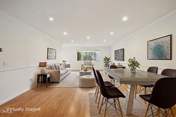 a view of a dining room with furniture and wooden floor