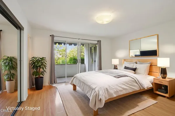 a bedroom with a bed and a potted plant