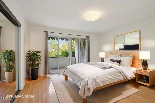 a bedroom with a bed and a potted plant