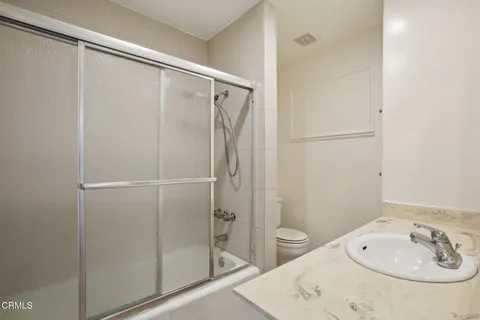 a bathroom with a shower and a sink