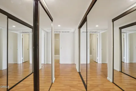 a view of hallway with wooden floor