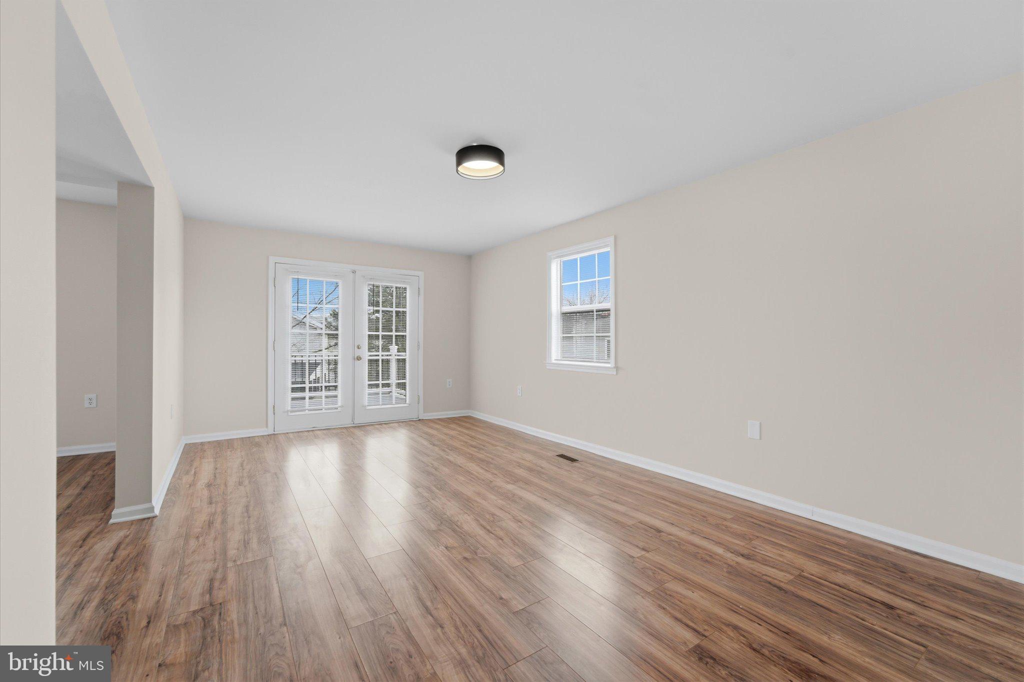 13511 Chevy Chase Court Chantilly, VA 20151 - Photo 11 of 57 an empty room with wooden floor and windows