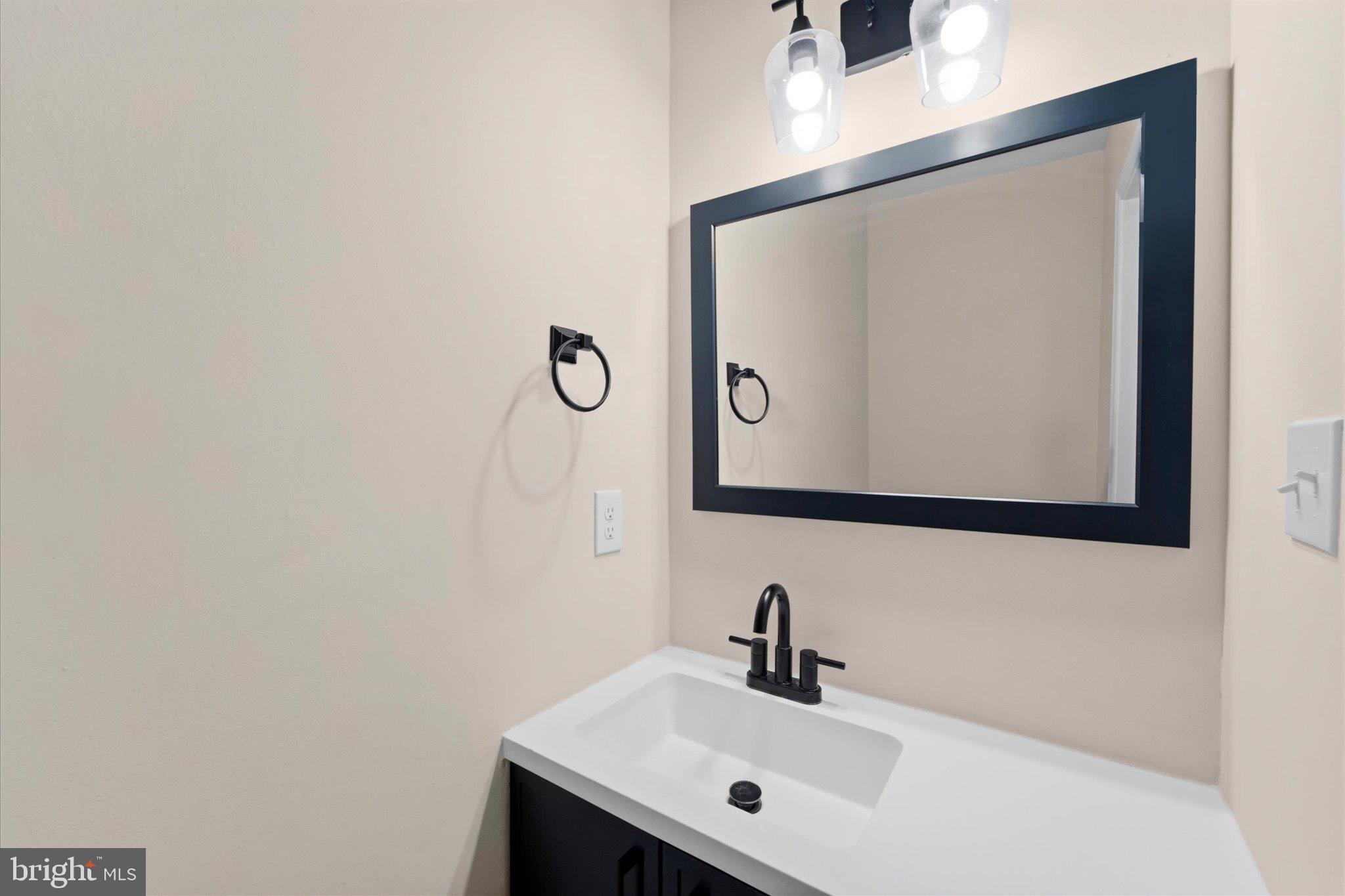 13511 Chevy Chase Court Chantilly, VA 20151 - Photo 16 of 57 a bathroom with a sink and a mirror