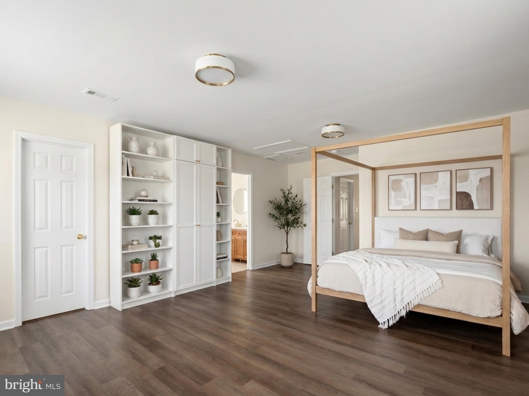 13511 Chevy Chase Court Chantilly, VA 20151 - Photo 19 of 57 a bedroom with a large bed and a wooden floor