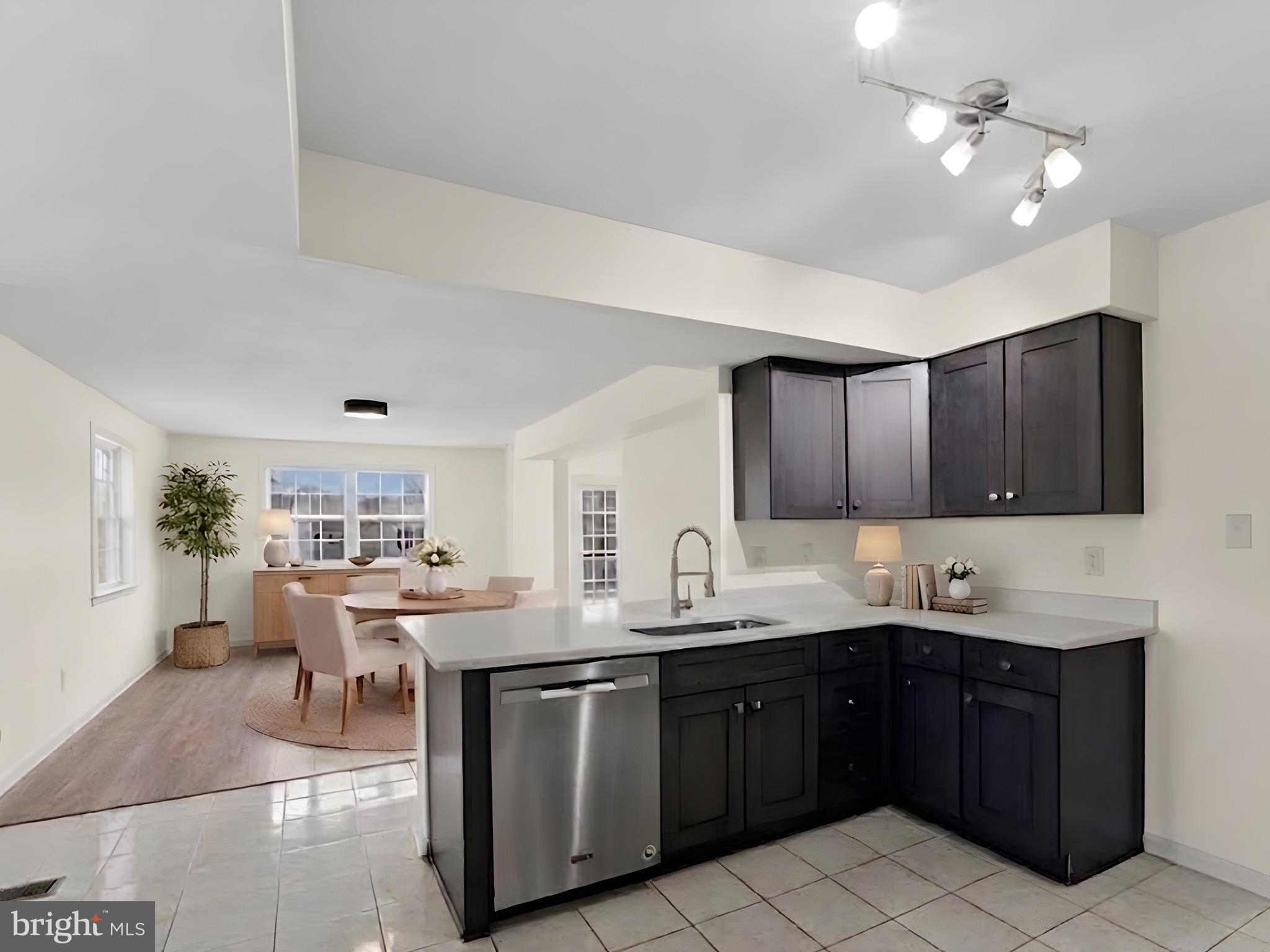 13511 Chevy Chase Court Chantilly, VA 20151 - Photo 3 of 57 a kitchen with a sink dishwasher a stove a refrigerator and cabinets