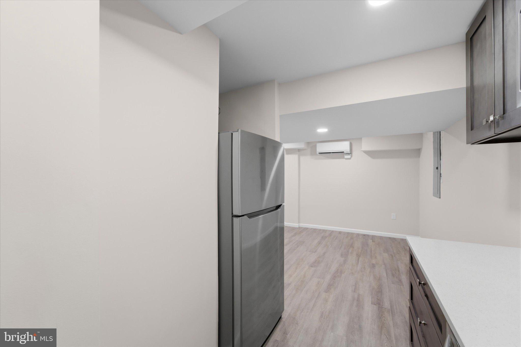 13511 Chevy Chase Court Chantilly, VA 20151 - Photo 38 of 57 a view of a room with wooden floor and a refrigerator