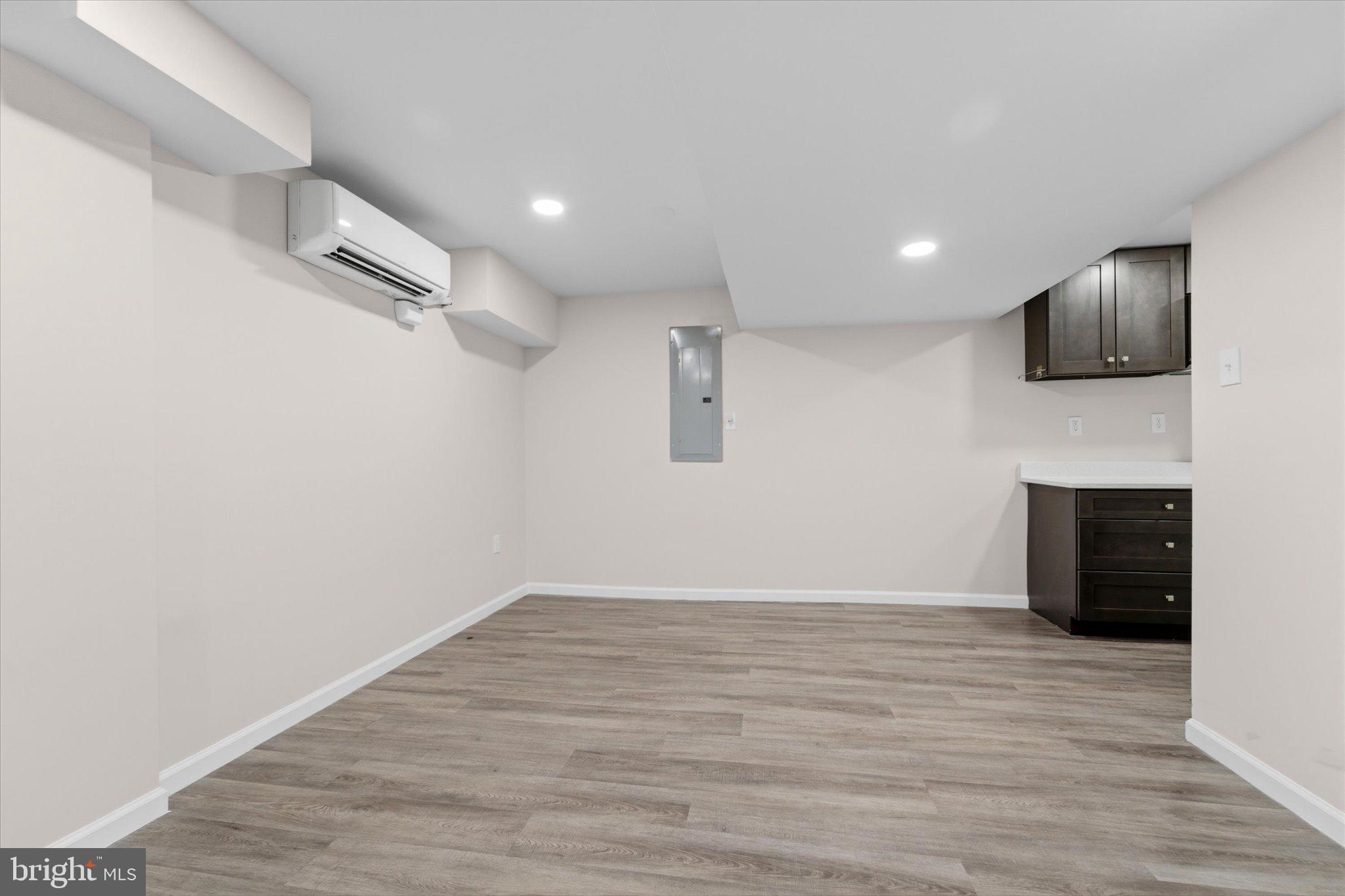 13511 Chevy Chase Court Chantilly, VA 20151 - Photo 40 of 57 a view of an empty room with wooden floor and a fireplace