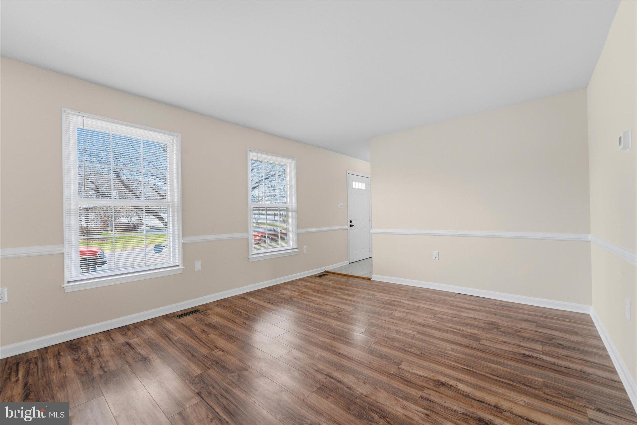 13511 Chevy Chase Court Chantilly, VA 20151 - Photo 9 of 57 an empty room with wooden floor and windows