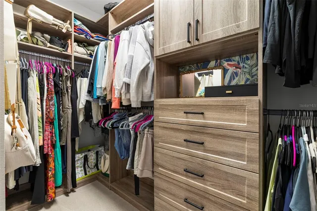 a living room with fireplace furniture and a large window