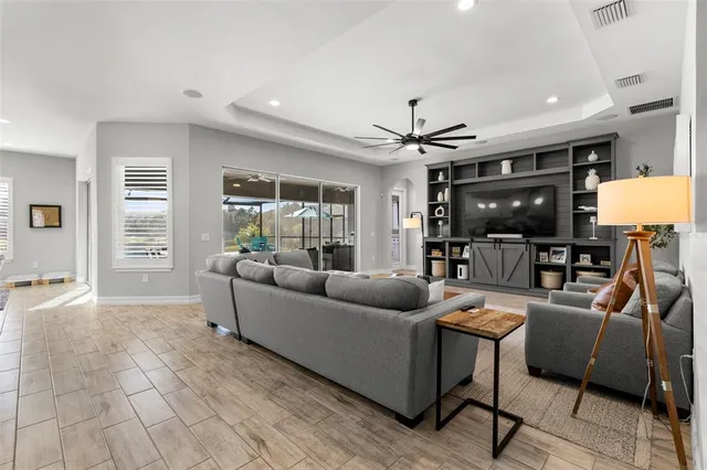 a large kitchen with cabinets a sink a stove and chairs