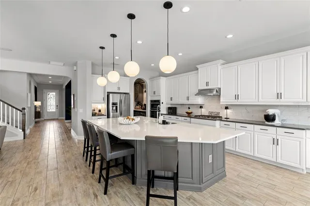 a kitchen with counter top space a sink appliances and cabinets