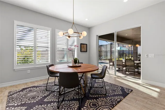 a living room with furniture and a dining table with wooden floor