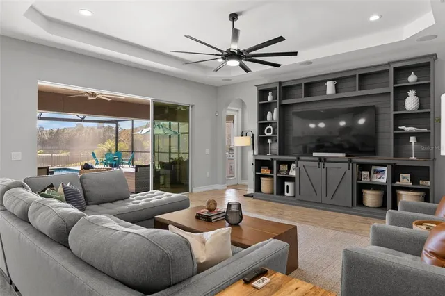 a view of a hallway with wooden floor and stairs
