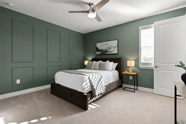 a bedroom with a bed and a flat tv screen on dresser