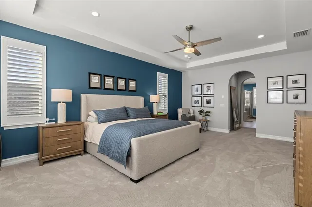 a living room with dining table furniture and a floor to ceiling window