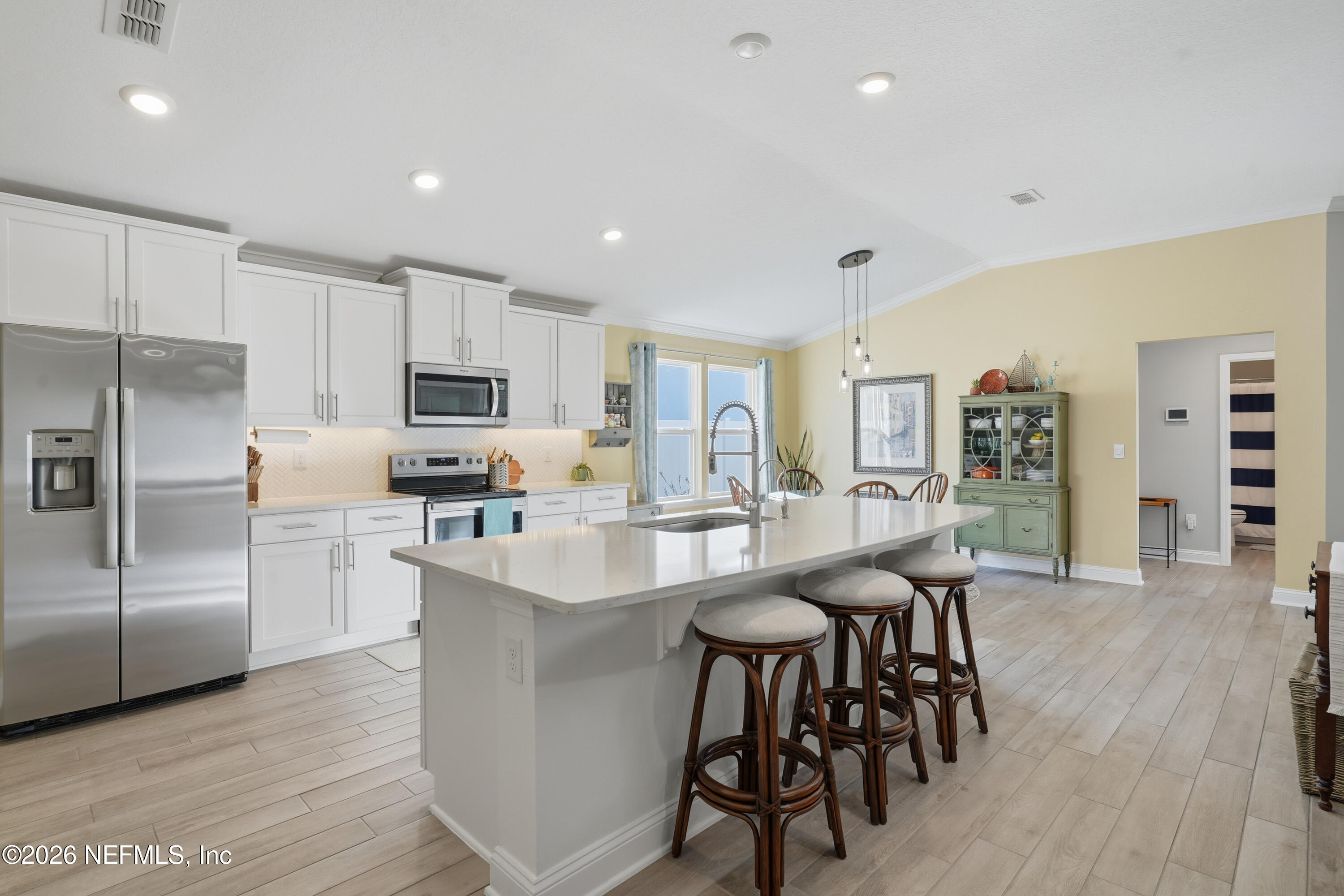 71 Gypsum Pl Street St. Augustine, FL 32086 - Photo 13 of 42 a kitchen with stainless steel appliances a dining table chairs refrigerator and sink