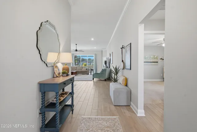 a living room with furniture a mirror and white walls