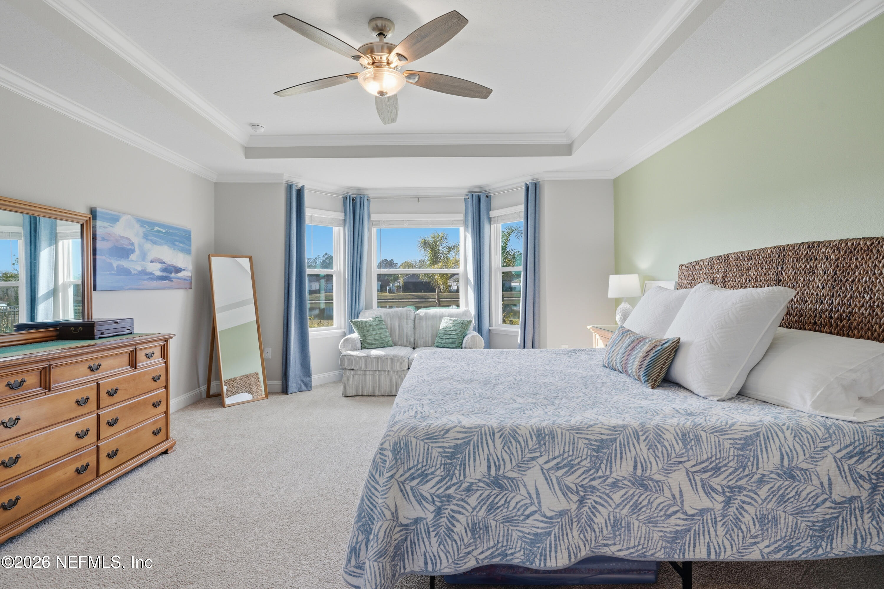 71 Gypsum Pl Street St. Augustine, FL 32086 - Photo 18 of 42 a bedroom with a large bed and a chandelier