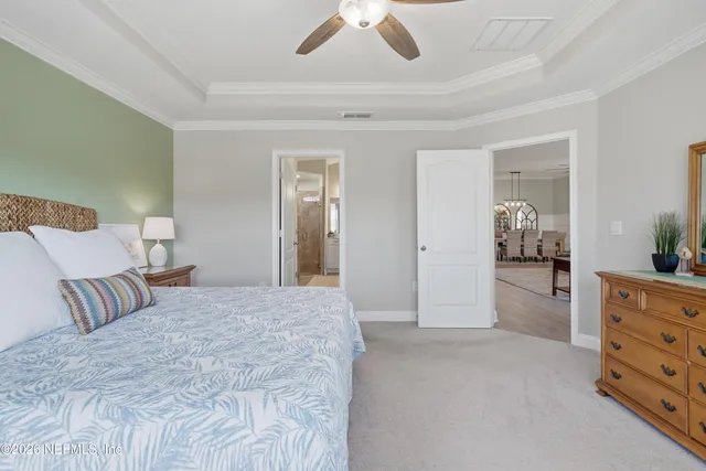 a spacious bedroom with a bed and a cabinets