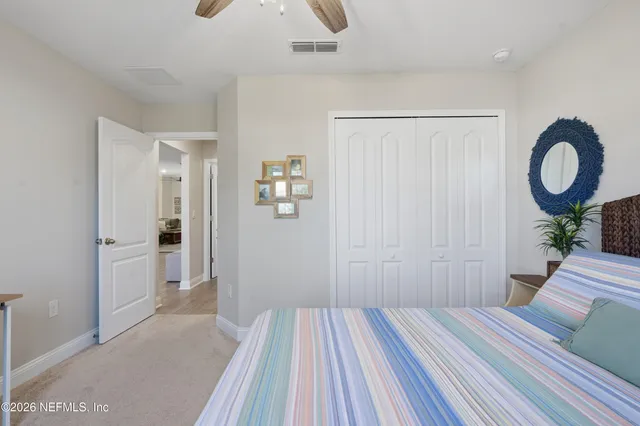 a bedroom with a bed and a large mirror