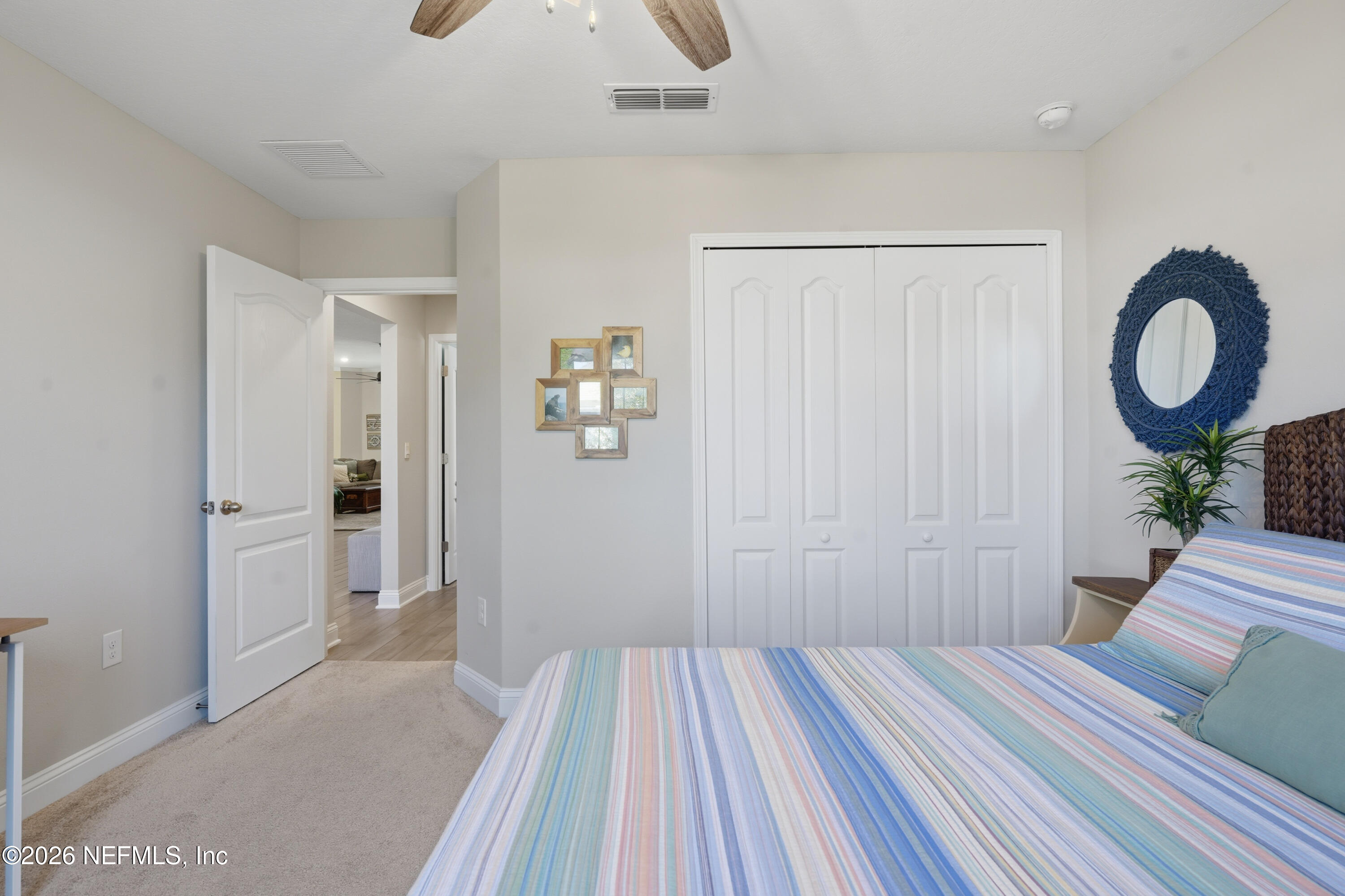 71 Gypsum Pl Street St. Augustine, FL 32086 - Photo 27 of 42 a bedroom with a bed and a large mirror