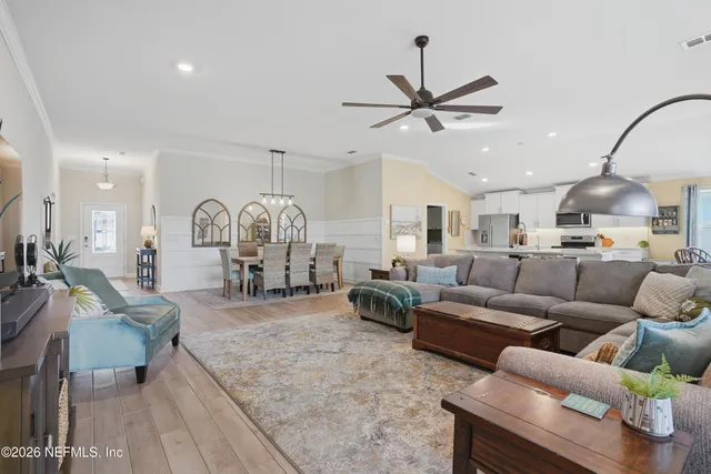 a living room with furniture a table and a chandelier