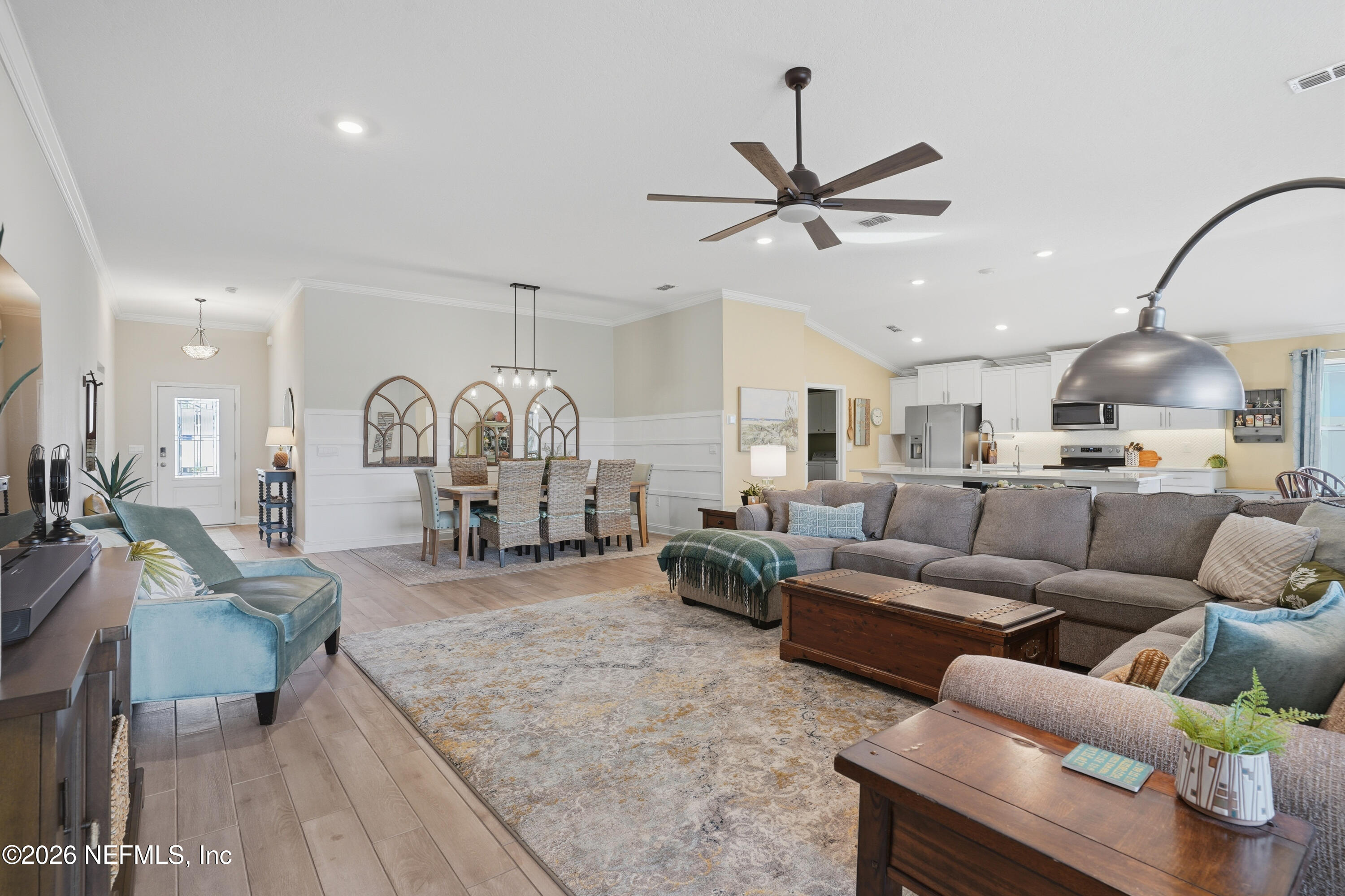 71 Gypsum Pl Street St. Augustine, FL 32086 - Photo 7 of 42 a living room with furniture a table and a chandelier