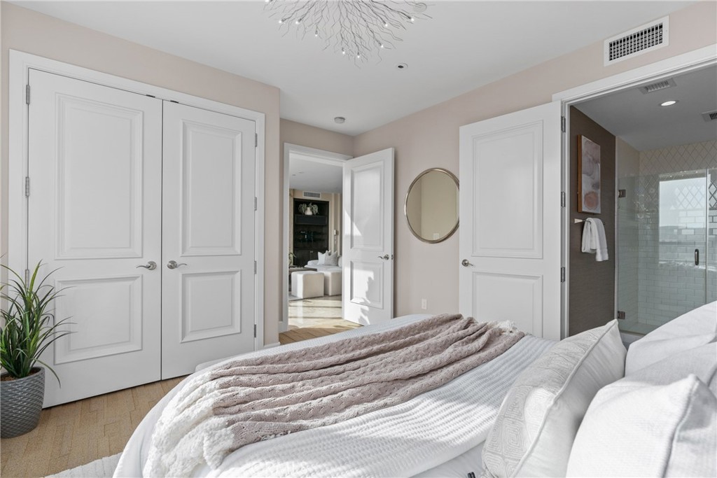 5153 Scholarship Irvine, CA 92612 - Photo 12 of 45 a bedroom with a large bed and a chandelier