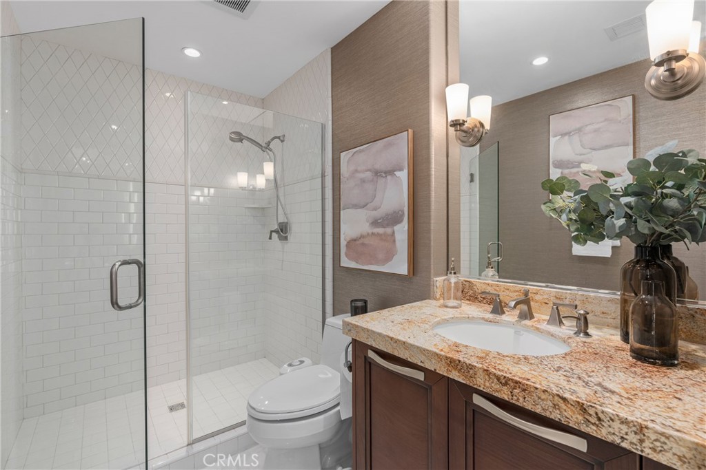 5153 Scholarship Irvine, CA 92612 - Photo 13 of 45 a bathroom with a granite countertop sink a toilet and shower