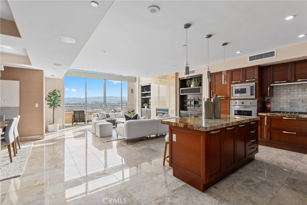 5153 Scholarship Irvine, CA 92612 - Photo 4 of 45 a living room with couches and kitchen view with wooden floor