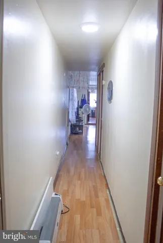 a view of hallway with wooden floor