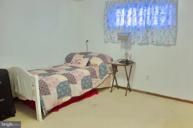 a bedroom with a bed and a chair