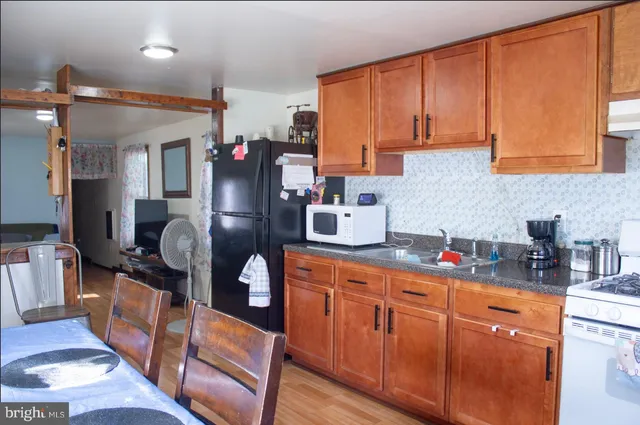 a kitchen with stainless steel appliances granite countertop a refrigerator and stove