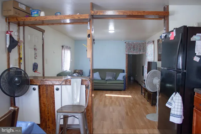 a living room with furniture a dining table and chairs