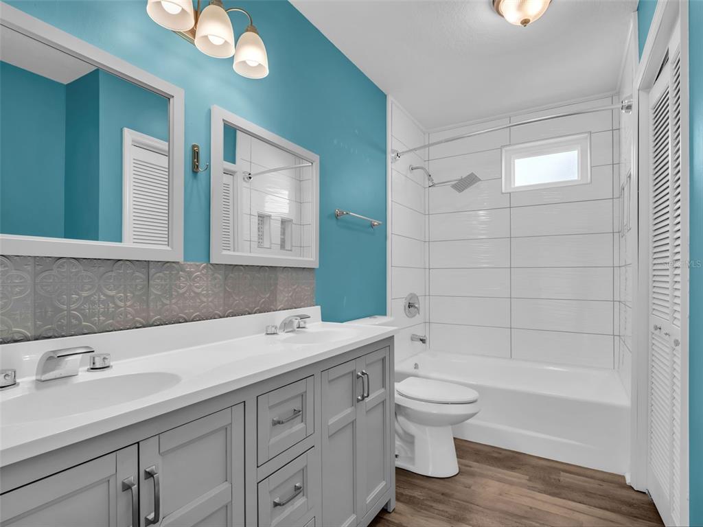 6241 Bayside Drive New Port Richey, FL 34652 - Photo 44 of 78 a bathroom with a double vanity sink toilet and shower