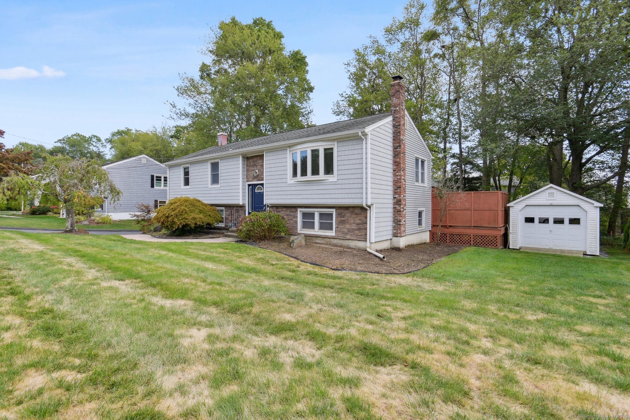 25 Carmen Road Milford, CT 06460 - Photo 16 of 21 a view of a house with a big yard plants and large trees
