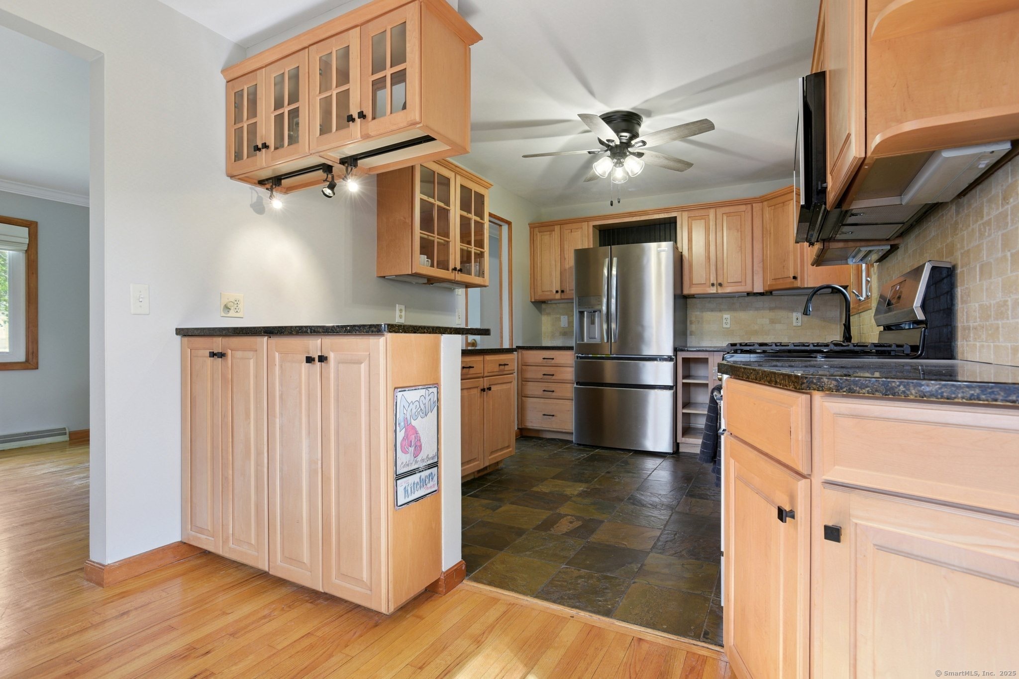 25 Carmen Road Milford, CT 06460 - Photo 4 of 21 a kitchen with stainless steel appliances granite countertop a refrigerator a stove and a sink with wooden floor