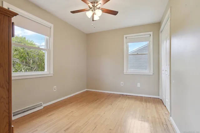 wooden floor in an empty room with a window
